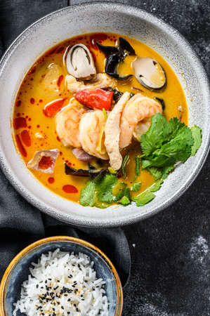 Tom yam kong or Tom yum, spicy clear soup.Tom Yam. Black background. Top view.