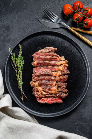 Grilled sliced Steak Rib eye with Pepper. black background. top view.の写真素材