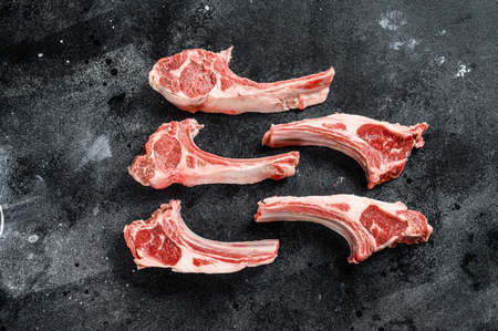 Raw lamb chops, Rack of Lamb. Black background. Top view.