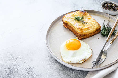 Croque Monsieur a traditional French toasted cheese and ham sandwich with bechamel sauce. White background. Top view. Copy space.の写真素材