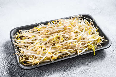 Bean sprout in black plastic container. White background. Top view.の写真素材