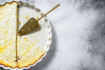 Cottage cheese casserole in a baking dish. Gray background. Top view. Copy space.