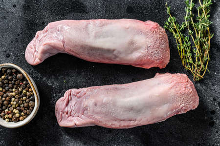 Boiled pork tongue. Organic meat offal. Black background. Top view.