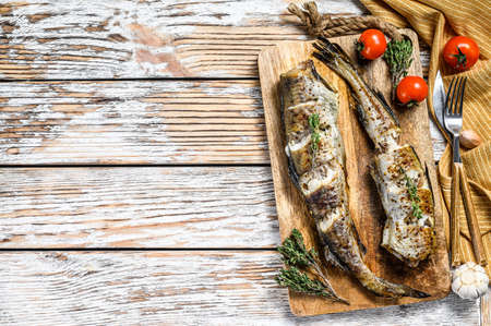 Oven baked pollock cooked in a savory marinade. White background. Top view. Copy space.の写真素材