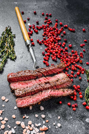 Grilled sliced Denver steak. Barbecue beef. Black background. Top view.の写真素材
