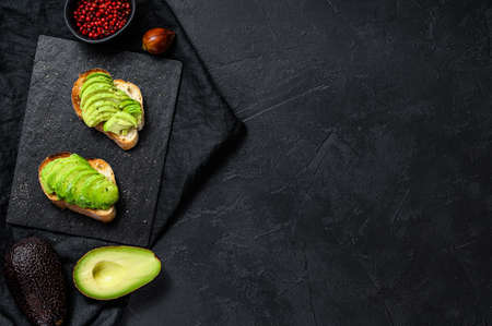 Avocado toast. Black background. Top view. Space for text.の写真素材