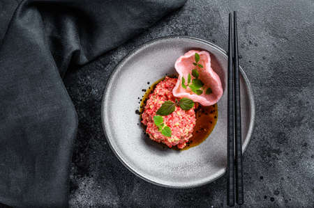 Fresh salmon tartare in Japanese style. Black background. Top view.の写真素材
