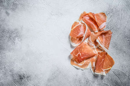 Italian prosciutto crudo, cured ham. White background. Top view. Copy space.の写真素材