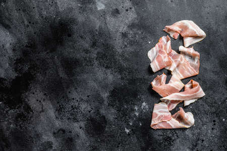 Raw pork bacon. Organic fresh meat. Black background. Top view. Copy space.の写真素材