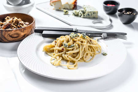 Spaghetti pasta with blue Gorgonzola cheese sauce. White background. Top view.の写真素材