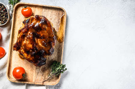 Roasted pork neck meat with spices on cutting board. Gray background. Top view. Copy space.の写真素材