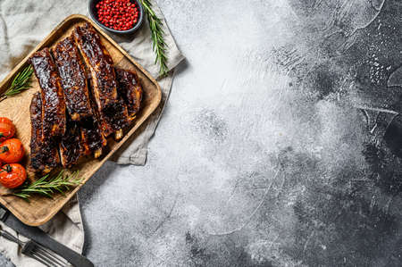 Roasted sliced barbecue pork ribs. Grilled meat. Gray background. Top view. Space for text.の写真素材