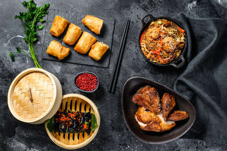 Chinese food. Noodles, dumplings, stir fry chicken, dim sum, spring rolls. Chinese cuisine set. Black background. Top viewの写真素材