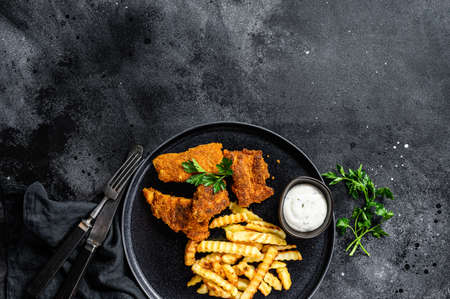 Fish and chips, traditional English food. Black background. Top view. Copy spaceの写真素材