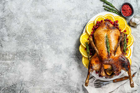 Roast duck with oranges and rosmarina. Gray background. Top view. Space for textの写真素材