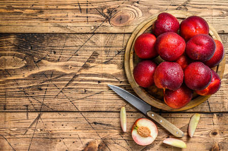 Tray of Fresh red nectarines. Wooden background. Top view. Copy space.の写真素材