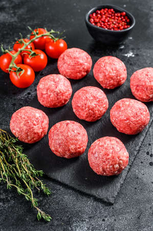 Raw meatballs, minced pork meat. Black background. Top view.の写真素材