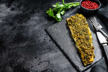 Fried fish fillet hake. Organic seafood. Black background. Top view. Copy space.