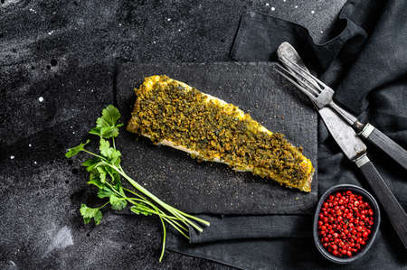 Baked cod fillet. Organic fish. Black background. Top view.