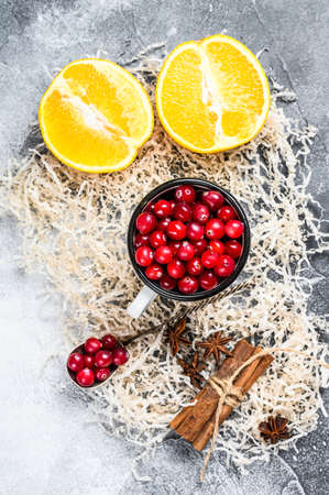 Mulled Wine recipe. Ingredients with cranberries, oranges, cinnamon, anise and cardamom. Gray background. Top view.の写真素材