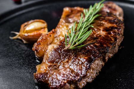 Beef strip loin steak on black background. Space for text. Marble premium beef. Close upの写真素材