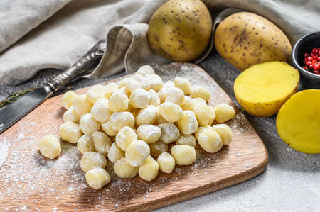 Handmade gnocchi di patata, traditional italian pasta ready for cooking. Gray background. Top view.の写真素材