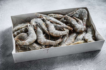 Frozen fresh big shrimps, prawns prepared for seafood cooking. White background. Top view. Copy space.の写真素材