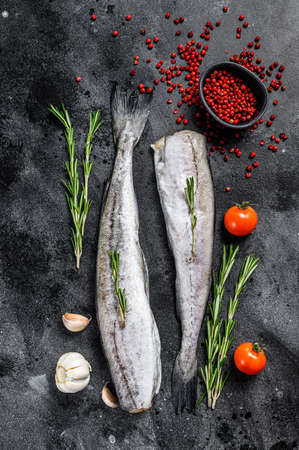 Fresh Pollock fish. Raw seafood. Black background. Top view.の写真素材