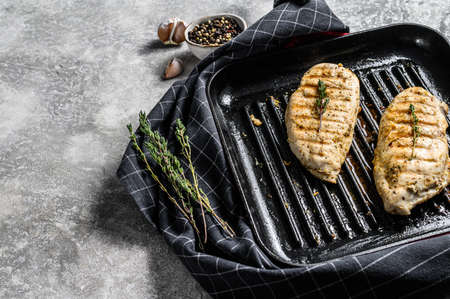 Grilled chicken fillet breasts on a cooking pan. gray background. Top view. Copy space.の写真素材
