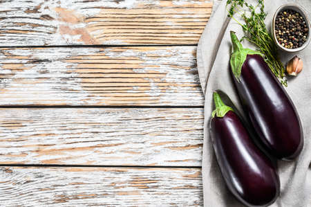 Raw purple eggplant. Organic vegetables. White background. Top view. Copy space.の写真素材