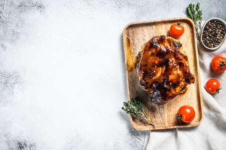 Roasted pork neck loin, baked meat. Gray background. Top view. Copy space.の写真素材