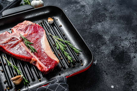 Porterhouse raw steak. Organic meat beef. Black background. Top view. Copy spaceの写真素材