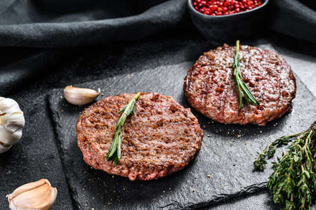 Grilled ground beef patties. BBQ meat. Black background. Top view.の写真素材