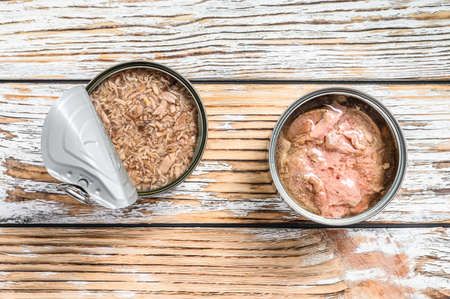 Canned tuna in a jar. Gray wooden background. Top view. Copy space.の写真素材
