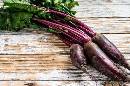 Organic purple beetroots. Wooden light background. Top view. Copy space.