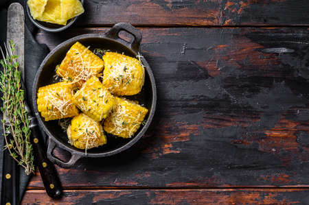 Grilled corn With a sprinkle of cheese, mexican elotes. Dark Wooden background. Top view. Copy space.の写真素材