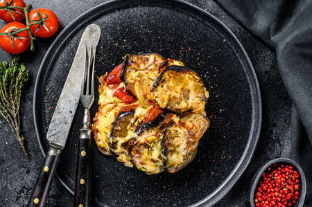 Vegetable ratatouille on a plate. French Provencal casserole. Black background. Top view.の写真素材