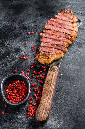 Grilled marbled beef steak. Black background. Top view.の写真素材