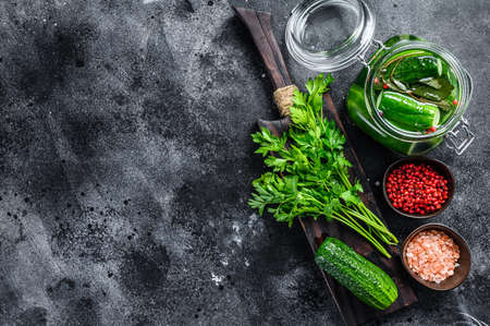 Green salted cucumbers. Canned vegetables. Black background. Top view. Copy space.の写真素材