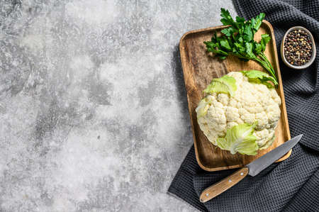 Fresh whole organic cauliflower with leaves. Gray background. Top view. Copy space.の写真素材