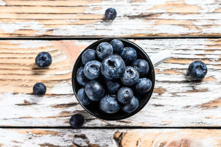 Blueberry in a white cup. antioxidant organic superfood. concept for healthy eating. White background. Top view.の写真素材