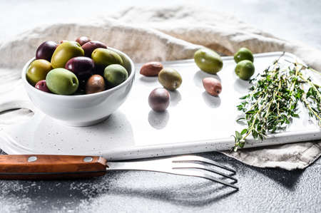Mix of colored olives with a bone. Gray background. Top view.の写真素材