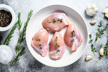Raw chicken drumstick fillet. Farm poultry meat. Gray background. Top view.の写真素材