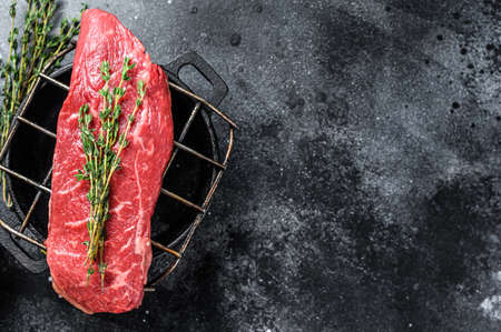 Raw Sirloin steak, beef meat. Dark Wooden background. Top view. Copy space.の写真素材