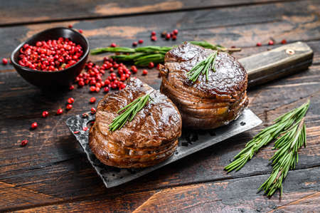 Medallions steaks from the beef tenderloin. Dark wooden background. Top view.の写真素材