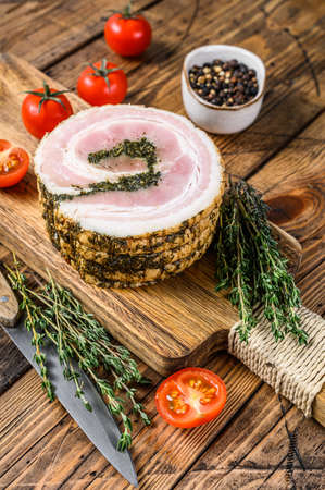 Italian traditional bacon pancetta on a cutting board. Wooden background. Top view.の写真素材