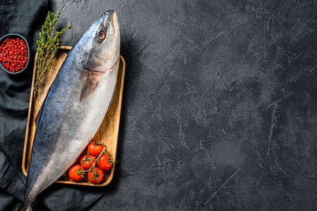 Fresh whole Japanese amberjack. Raw Fish Yellowtail. Black background. Top view. Copy space.の写真素材