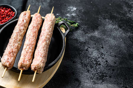 Raw turkish traditional meat kebab. Black background. Top view. Copy space.の写真素材