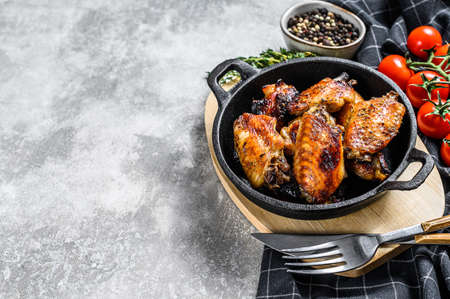 Barbecue chicken wings in honey sauce. BBQ poultry meat. Gray background. Top view. Copy space.の写真素材