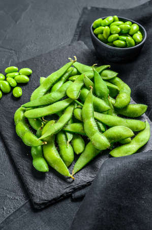 Raw Green edamame soybeans. Black background. Top view.の写真素材